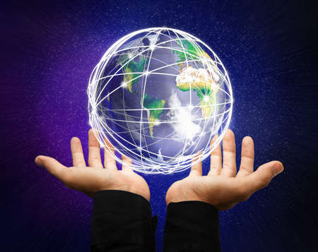 holding a glowing earth globe in his handsの写真素材