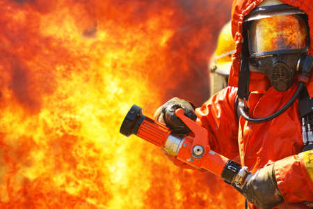 Firefighters fighting fire during trainingの写真素材