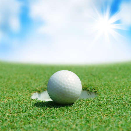 Golf ball on green teeの写真素材