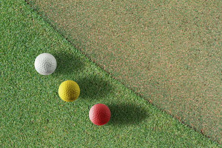 Golf ball on green teeの写真素材