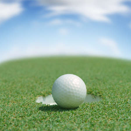 Golf ball on green teeの写真素材
