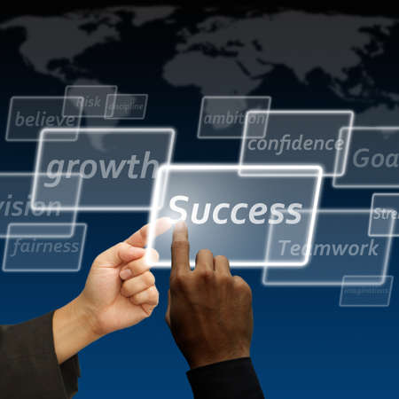 Young stylish businessman touching virtual interface buttonの写真素材