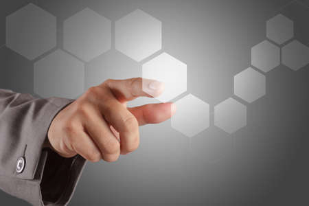 business man hand pushing on a virtual touch screen interfaceの写真素材