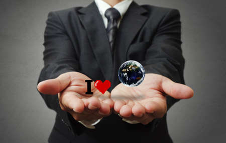 business man hand holds I love the earth as concept, elements of this image furnished by NASAの写真素材