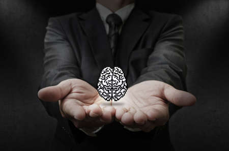 business man hand shows pixel brain icon as conceptの写真素材