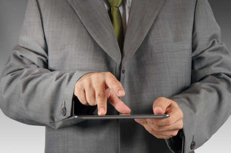 close up of business man hand working on a digital tabletの写真素材