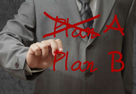 businessman hand drawing plan a plan bの写真素材