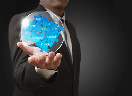 business man shows business puzzles with glass shieldの写真素材