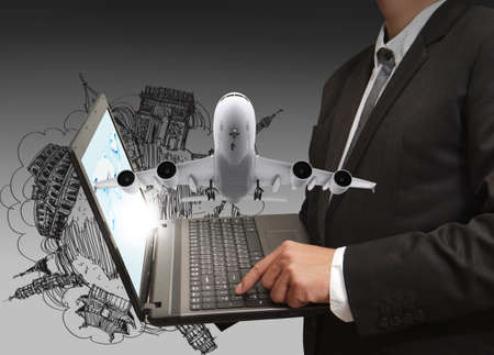 business man shows laptop and dream travelの写真素材