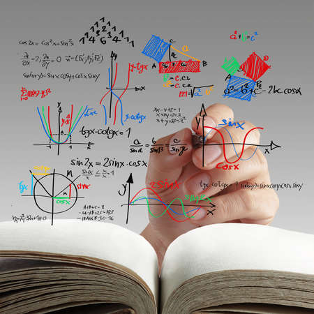 male teacher writing various high school maths and science formula on whiteboard