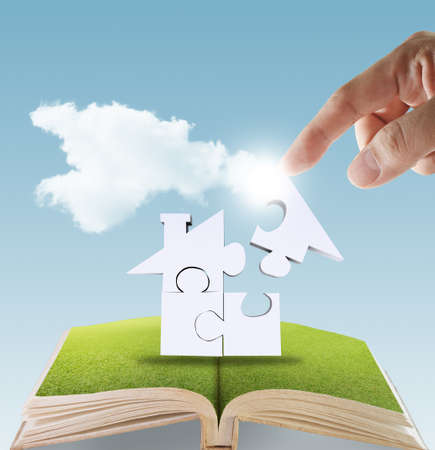 open book of hand complete puzzle home as conceptの写真素材