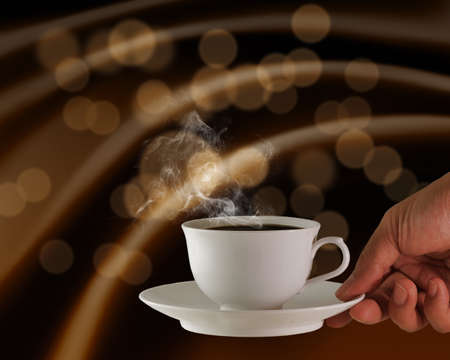 hand holds a cup of hot coffeeの写真素材