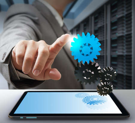 business man touch on gear as computer solution conceptの写真素材