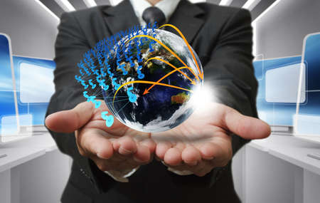 Business man hand holds globe and social networkの写真素材