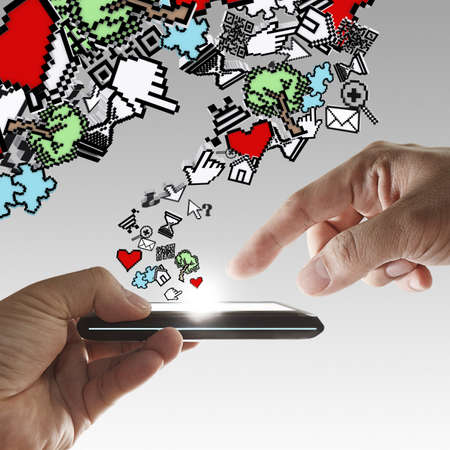 floating pixel computer icons with hand touch smart phoneの写真素材