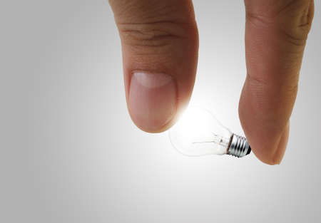 fingers pick light bulbの写真素材