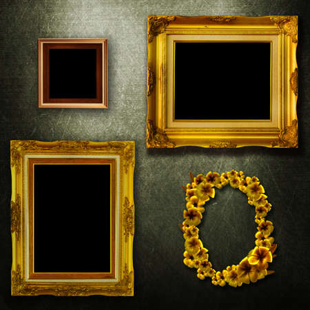 Gallery display - vintage gold frames on an old timber wallの写真素材