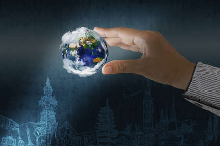 holding a glowing earth globe in his handsの写真素材