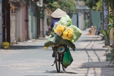 woman on a bike in vietnamの写真素材