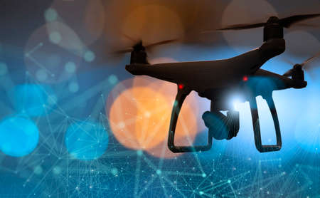 Drone quad copter with high resolution digital camera on the abstract city background.