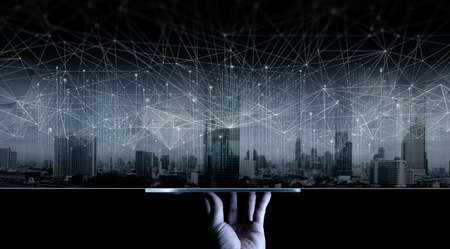 Hand show digital tablet display Wireless network and Connection technology concept covering on...