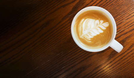top view of Hot art Latte Coffee in a cup on wooden table.の写真素材