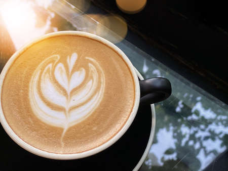 Hot art Latte Coffee in a cup on table background.の写真素材