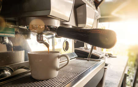Close-up of espresso pouring from coffee machine by Professional coffee brewing.の写真素材