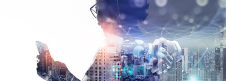 Cyber communication design concept. Ai robot and human holding hands with handshake. woman using smart phone technology concept.の写真素材