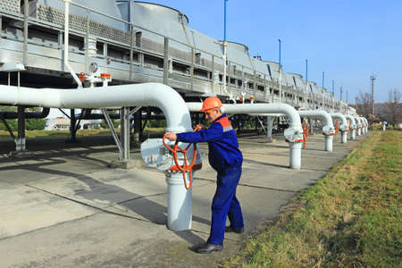 Worker closing valve on gas compressor stationの写真素材