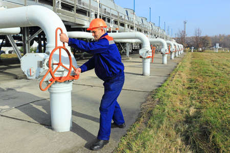 Worker closing valve on output installations of gas compressor stationの写真素材