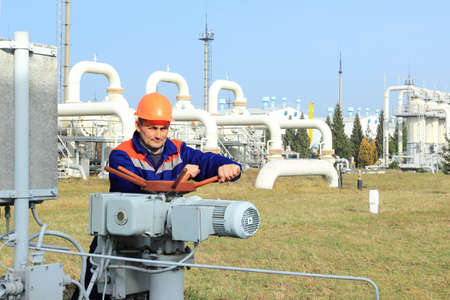 Worker closing bypass valve on gas compressor stationの写真素材
