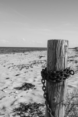 jamb with chain at the beachの写真素材