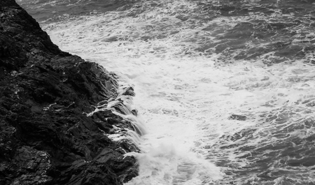 Waves crashing into the cliffs of Cornwallの写真素材