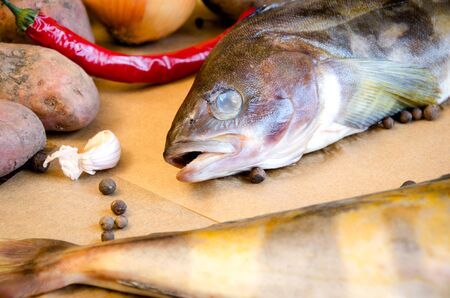 grinling fish with vegetables on baking paper closeupの写真素材