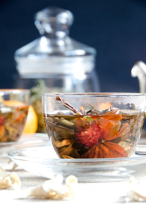 oolong tea in glass cups with mint with fruit and glass kettleの写真素材
