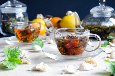 two cups oolong tea glass with fruit and glass kettleの写真素材