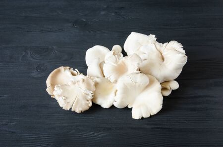 white mushrooms black wooden tableの写真素材