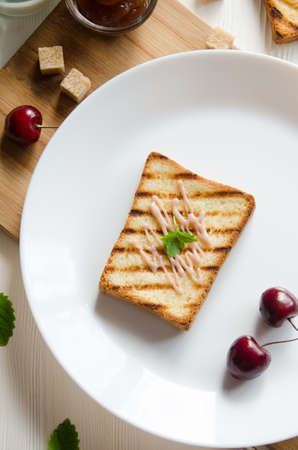 toasts white round plate with cream and mint leaves top view flat layの写真素材