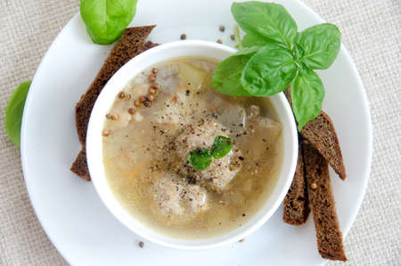 buckwheat soup meatballs white plate basil bread on a gray background flat layの写真素材