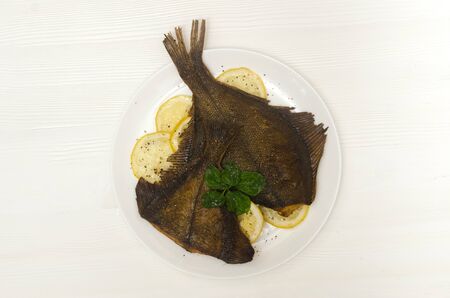 prepared sole round white plate lemon on a white background Flat layの写真素材