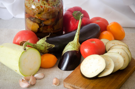 canned eggplant squash tomato garlic cutting board on light backgroundの写真素材