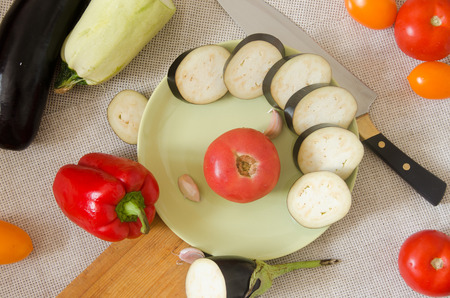 sliced eggplant green plate vegetables top view on a gray backgroundの写真素材