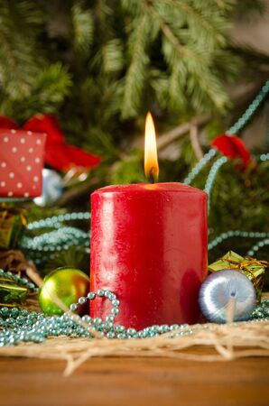 christmas candle balls fir branches close up on a colored backgroundの写真素材