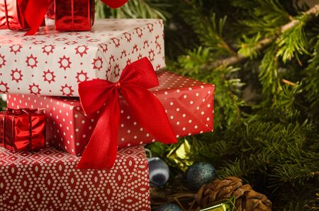 christmas gifts fir branches cones with red bows copy space close upの写真素材