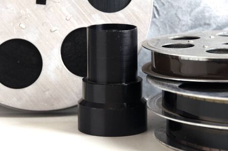 objective film reels with cinema accessories on white background	