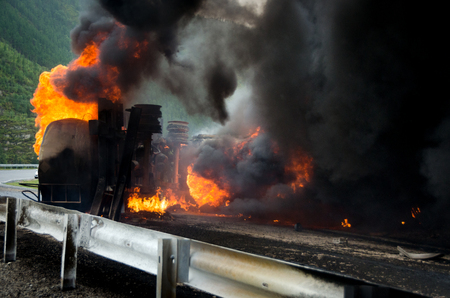 Burning tank truck road accident on the track selective focus の写真素材
