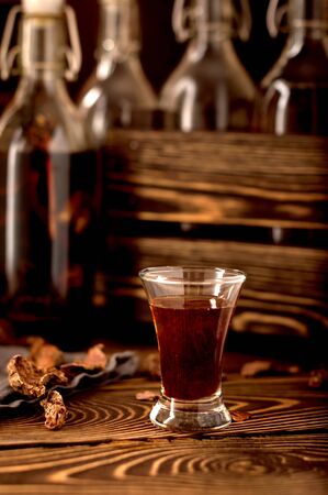 hooch moonshine alcohol  herbs  on a rustic wooden background with bottles and wooden boxの写真素材