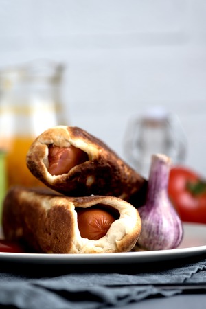 baked sausages dough tomato garlic juice on a rustic backgroundの写真素材