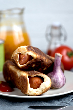 sausages dough sea buckthorn tomato garlic juice on a rustic backgroundの写真素材